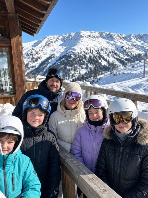 a group in ski gear on a snowy mountain terrace